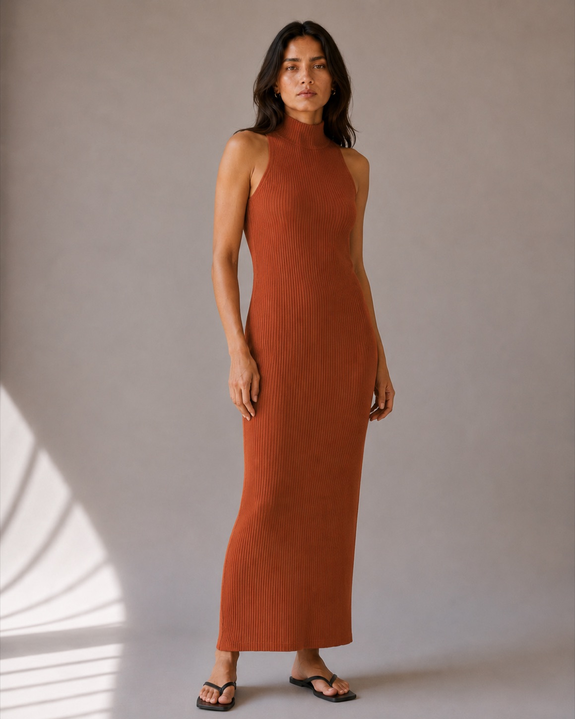 A model in the Ilva Knit Column Dress in rust, the product being viewed